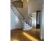 Bright foyer boasts a winding staircase and decorative glass door with gleaming hardwood floors at 1200 Bay Pointe Terr Ter, Alpharetta, GA 30005