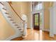 Grand foyer with curved staircase and stained glass window over front door at 1200 Bay Pointe Terr Ter, Alpharetta, GA 30005