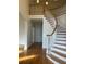 Elegant foyer featuring a curved staircase with hardwood steps, and bright, open space at 1200 Bay Pointe Terr Ter, Alpharetta, GA 30005