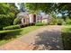 Brick home with driveway and lush green lawn at 1200 Bay Pointe Terr Ter, Alpharetta, GA 30005
