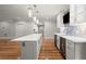 Elegant kitchen featuring a waterfall island, wood floors, and sleek cabinetry at 1200 Bay Pointe Terr Ter, Alpharetta, GA 30005