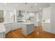 Elegant kitchen with white cabinets, stone backsplash, marble countertops, and a center island at 1200 Bay Pointe Terr Ter, Alpharetta, GA 30005