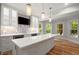 Well-lit kitchen with island, wood floors, and wine storage at 1200 Bay Pointe Terr Ter, Alpharetta, GA 30005