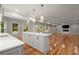 Bright open-concept kitchen with island, hardwood floors, and a fireplace at 1200 Bay Pointe Terr Ter, Alpharetta, GA 30005