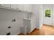Functional laundry room with sink, cabinets, and convenient access to the backyard at 1200 Bay Pointe Terr Ter, Alpharetta, GA 30005