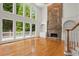 Bright living room boasts a stone fireplace, built-in shelves, and a wall of large windows at 1200 Bay Pointe Terr Ter, Alpharetta, GA 30005