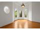 Sunlit living room features wood floors and arched windows at 1200 Bay Pointe Terr Ter, Alpharetta, GA 30005
