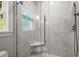 Modern walk-in shower with glass door and leafy tiled walls at 1200 Bay Pointe Terr Ter, Alpharetta, GA 30005