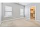 Bright bedroom featuring neutral walls, plush carpet, and a walk-in closet for ample storage at 1405 Attwater Dr, Atlanta, GA 30316