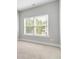 Empty bedroom featuring a window with white trim and plush tan carpeting at 1405 Attwater Dr, Atlanta, GA 30316