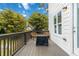 Outdoor deck featuring seating area, contrasting with the home's white exterior and surrounding trees at 1405 Attwater Dr, Atlanta, GA 30316