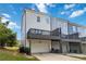 Townhome exterior featuring a private garage and a charming balcony overlooking the yard under a blue sky at 1405 Attwater Dr, Atlanta, GA 30316