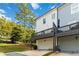 Townhome exterior with a garage, balcony, and view of the surrounding landscaping under a blue sky at 1405 Attwater Dr, Atlanta, GA 30316