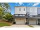 Townhome exterior featuring a private garage and a charming balcony overlooking the yard under a blue sky at 1405 Attwater Dr, Atlanta, GA 30316