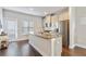 Bright kitchen with stainless steel appliances, granite counters, white cabinets and an adjacent door to the outside at 1405 Attwater Dr, Atlanta, GA 30316