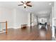Open-concept living room with dining area, hardwood floors, a fan and adjacent staircase at 1405 Attwater Dr, Atlanta, GA 30316