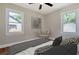 Bright bedroom with large windows, neutral decor, and a stylish ceiling fan at 1849 Broad Ave, Atlanta, GA 30344