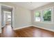 Spacious bedroom with hardwood floors and large windows provides ample natural light at 1849 Broad Ave, Atlanta, GA 30344