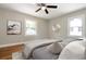 Inviting bedroom with hardwood floors, ceiling fan, and ample natural light from two windows at 1849 Broad Ave, Atlanta, GA 30344