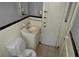 Outdated bathroom with a toilet, sink, mirror, and tile at 2172 Jernigan Drive Se, Atlanta, GA 30315