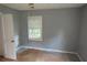 Bedroom featuring a window with blinds, grey walls, and wood floors at 2172 Jernigan Drive Se, Atlanta, GA 30315