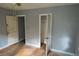 Bedroom featuring two doors, grey walls, and wood floors at 2172 Jernigan Drive Se, Atlanta, GA 30315