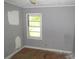 Bedroom features a window, grey walls, and wood floors at 2172 Jernigan Drive Se, Atlanta, GA 30315