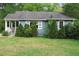 Traditional single story home with blue siding, lush landscaping, and a covered front porch at 2172 Jernigan Drive Se, Atlanta, GA 30315
