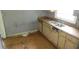 Kitchen featuring cabinetry and countertops, with worn wood flooring and ample natural light at 2172 Jernigan Drive Se, Atlanta, GA 30315