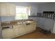 The kitchen features wood cabinets, a stainless-steel sink, and black and gray patterned backsplash at 2172 Jernigan Drive Se, Atlanta, GA 30315