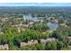 Aerial view of a townhome community near a lush golf course and a tranquil lake at 2664 Long Pointe, Johns Creek, GA 30076