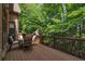 Relaxing back deck with patio furniture and a view of the wooded backyard at 2664 Long Pointe, Johns Creek, GA 30076