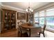 Formal dining room featuring hardwood floors, large windows, designer lighting and neutral paint at 2664 Long Pointe, Johns Creek, GA 30076