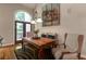 Charming dining room with a wooden table and chairs, with an arched doorway for an inviting meal space at 2664 Long Pointe, Johns Creek, GA 30076