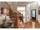 Foyer featuring hardwood floors, staircase with iron spindles, and views to formal dining room at 2664 Long Pointe, Johns Creek, GA 30076