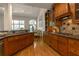 Gourmet kitchen with wooden cabinets, stone countertops, and modern appliances offers a warm and inviting space at 2664 Long Pointe, Johns Creek, GA 30076
