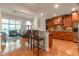 Open concept kitchen with custom cabinets, stainless steel appliances, and an eat-in bar overlooking the living room at 2664 Long Pointe, Johns Creek, GA 30076