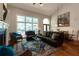 Bright living room with a fireplace, large windows, and stylish decor is perfect for Gathering gatherings at 2664 Long Pointe, Johns Creek, GA 30076