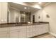 Elegant bathroom featuring dual vanities, granite countertops, and a glass-enclosed shower, offering a spa-like experience at 2664 Long Pointe, Johns Creek, GA 30076