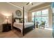 Serene bedroom with a four-poster bed, soft lighting, and large windows offers a peaceful retreat at 2664 Long Pointe, Johns Creek, GA 30076