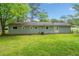 View of the back exterior with a well-manicured lawn at 3428 Quail Sw Run, Marietta, GA 30008