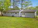 View of the back exterior with a well-manicured lawn at 3428 Quail Sw Run, Marietta, GA 30008