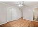 A well-lit bedroom features wood floors and double door closet with a fan on the ceiling at 3428 Quail Sw Run, Marietta, GA 30008