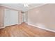 A serene bedroom includes wood floors, fan, and double door closet at 3428 Quail Sw Run, Marietta, GA 30008