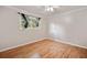 A comfortable bedroom with wood floors and a window showcasing the outdoor scenery at 3428 Quail Sw Run, Marietta, GA 30008