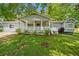 Charming single-story home boasts a inviting front porch and manicured lawn at 3428 Quail Sw Run, Marietta, GA 30008