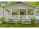 Charming covered front porch with white railings and view to the front door at 3428 Quail Sw Run, Marietta, GA 30008