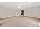Spacious living room with plush carpeting and a view into the kitchen at 3428 Quail Sw Run, Marietta, GA 30008
