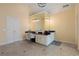 Bathroom vanity area with a black countertop, white cabinetry, oversized mirror, and decorative light fixture at 1000 Admiral Xing, Alpharetta, GA 30005