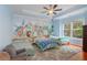 bedroom with animal wallpaper, three beds, ceiling fan, and large window at 1000 Admiral Xing, Alpharetta, GA 30005